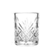 Shot glass with diamond shaped cut glass design on white background.