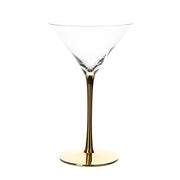 clear martini glass with gold stem on white background